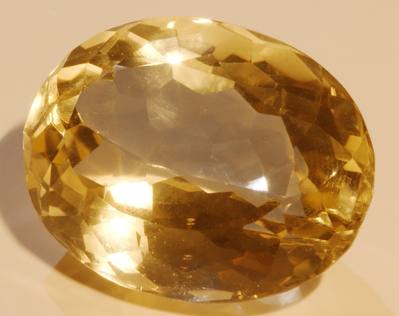 A faceted citrine gemstone from Minas Gerais, Brazil, showing its golden color
